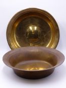 A LARGE RAISED BRASS BOWL WITH CONVEX CENTRE ROUNDEL 37CM DIA AND ANOTHER SIMILAR BOWL. 18TH CENTURY