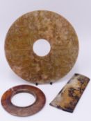 AN ARCHAISTIC CHINESE JADE BI DISC WITH CARVED DECORATION IN SHALLOW RELIEF TO BOTH SIDES 21 CM DIA.