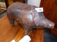 A VINTAGE LEATHER PIG FORM FOOTREST IN THE LIBERTY STYLE. 63CM LONG