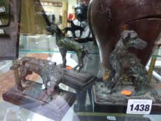 A GROUP OF THREE SMALL BRONZE SCULPTURE OF DOGS