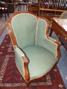 A CARVED FRENCH LOUIS XV STYLE ARMCHAIR OF WINGBACK TUB FORM