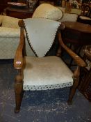 AN UNUSUAL OAK ARTS AND CRAFTS ARMCHAIR. WITH SHAPED SEAT AND BACK