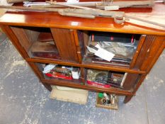 AN EARLY 20TH CENTURY OAK TWO SECTION TAMBOUR DOOR CABINET ON CONFORMING BASE