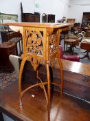 AN UNUSUAL OAK ART NOUVEAU STYLE STAND. WITH SHAPED LEGS AND ARCHED CROSS STRETCHERS