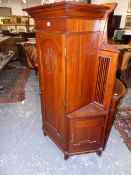AN UNUSUAL MAHOGANY ARTS AND CRAFTS CABINET. PIERCED CENTRAL PANEL DOOR FLANKED BY ANGLED CUPBOARDS