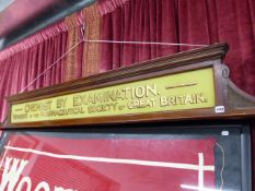 A LARGE MAHOGANY FRAMED AND REVERSE GLASS PAINTED CHEMIST BY EXAMINATION SIGN