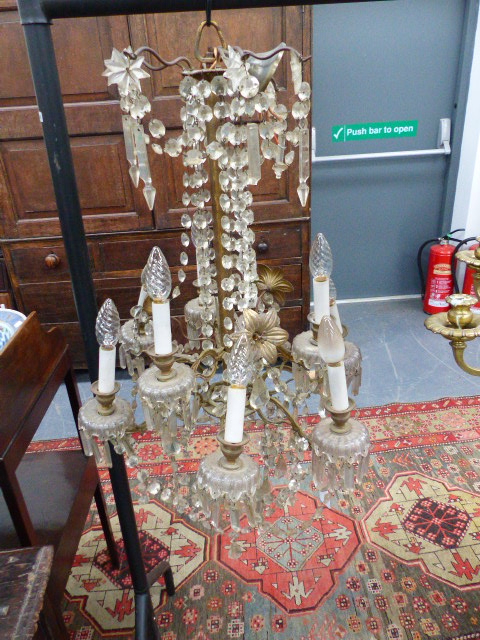 A VINTAGE FRENCH STYLE GILT BRASS FRAME NINE LIGHT CHANDELIER, FLOWER HEADS WITH SWAGS AND PRISMS