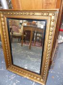 A REGENCY GILT RECTANGULAR MIRROR WITH EBONISED SLIP. 73 X 55CM