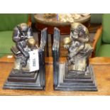 A PAIR OF BRONZE AND MARBLE BOOKENDS. EACH MOUNTED WITH A CHIMPANZEE HOLDING A SKULL SEATED ON A