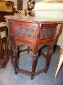 AN ARTS AND CRAFTS COLONIAL HARDWOOD CARVED AND INLAID OCTAGONAL OCCASIONAL TABLE. 64cms HIGH