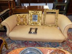 A VICTORIAN LOW BACK SCROLL ARM CHESTERFIELD TYPE SETTEE. APPROX. 195cms WIDE.