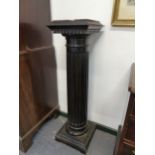 A PAIR OF EBONISED DISPLAY PLINTHS WITH MARBLE TOPS. 113cms HIGH