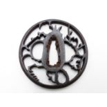 A 17TH CENTURY PIERCED IRON TSUBA DECORATED AFTER STYLIZED BIRDS WITHIN A PLUM TREE