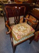 A GEORGIAN CARVED MAHOGANY ARMCHAIR. PIERCED GOTHIC SPLAT. NEEDLEWORK SEAT ANS LOOSE CUSHION