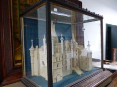 AN ANTIQUE GLAZED CASED DIORAMA OF AN IMPRESSIVE CONTINENTAL CHATEAU, THE CASE 66cms WIDE