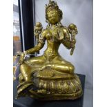 AN EASTERN POLISHED BRONZE AND COPPER FIGURE OF A SEATED DEITY ON A LOTUS FORM BASE. 18CM HIGH