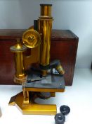 A LACQUERED BRASS MICROSCOPE BY R & J BECK, LONDON, No23057 IN A MAHOGANY CASE TOGETHER WITH A BLACK