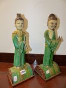 A PAIR OF CHINESE ROOF TILES, EACH OF A STANDING FIGURE ON CARVED HARDWOOD BASES.