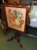 A VICTORIAN MAHOGANY FIRESCREEN WITH NEEDLEPOINT PANEL. 128cms HIGH