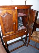 A SMALL 18TH.C.AND LATER OAK CABINET ON STAND.