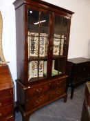 A GOOD GEORGIAN BURR WALNUT GLAZED BOOKCASE ON A TWO DRAWER BASE AND BRACKET FEET. 113cms WIDE.