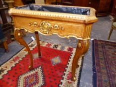 A GILT DECORATED JARDINIERE ON SHAPED SABRE LEGS. 76cms WIDE