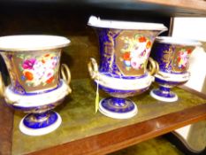 A GARNITURE OF THREE BLOOR DERBY CAMPANA SHAPED VASES PAINTED WITH ROSES, PASSION FLOWERS AND LILIES