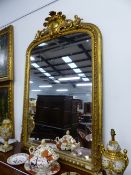 A LARGE VICTORIAN GILT FRAMED OVERMANTLE MIRROR WITH CARVED CREST. APPROX 170cms HIGH x 121 WIDE