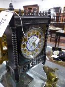 A VICTORIAN ARTS AND CRAFTS EBONISED MANTLE CLOCK WITH BLUE AND WHITE DECORATED DIAL.