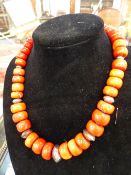 A TRIBAL GRADUATED CORAL BEAD NECKLACE. 51CM LONG