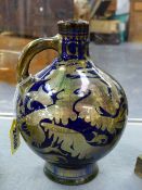 A PILKINGTONS LANCASHIRE FLAGON WITH DARK BLUE AND SILVERED LUSTRE SCROLL WORK DECORATION.