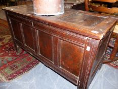 A SMALL EARLY 18TH.C.OAK PANEL FRONT AND PANEL TOP COFFER. 114cms WIDE.