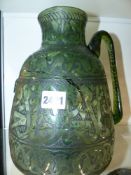 AN ISLAMIC ENGRAVED GLASS EWER. 26CM HIGH