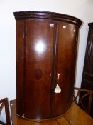 AN 18TH.C.OAK AND MAHOGANY BANDED BOW FRONT CORNER CABINET.