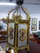 A GILT BRASS FRAMED STAINED GLASS HALL LANTERN.