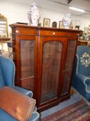 A SMALL VICTORIAN MAHOGANY BREAKFRONT GLAZED BOOKCASE. 123cms WIDE