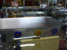 AN ENGINE TURNED SILVER CEDAR LINED PRESENTATION CIGARETTE BOX WITH ENAMELLED BOSSES OF PENANG,