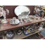 AN EXTENSIVE COLLECTION OF ANTIQUE AND LATER PLATED WARES, TO INCLUDE TRAYS, SERVING DISHES, URNS