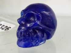 A TIBETAN BLUE HARDSTONE MODEL OF A SKULL. 5CM HIGH