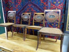 A SET OF SIX REGENCY SATINWOOD PAINTED SIDE CHAIRS WITH PAINTED PANEL AND CANED BACKS AND CANE