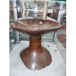 AN ANTIQUE TRIBAL DISH TOP STOOL