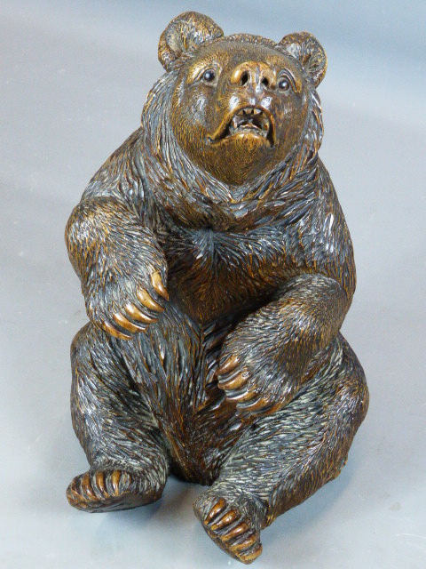 AN UNUSUAL FINELY CARVED BLACK FOREST FIGURE OF A SEATED BEAR WITH GLASS EYES AND BRASS TRADE LABEL,