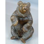 AN UNUSUAL FINELY CARVED BLACK FOREST FIGURE OF A SEATED BEAR WITH GLASS EYES AND BRASS TRADE LABEL,