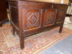 AN 18TH.C.OAK COFFER WITH THREE CARVED PANEL FRONT. 112cms WIDE