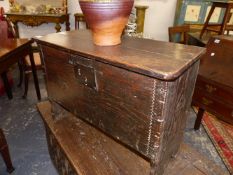 AN ANTIQUE OAK PLANK COFFER OF A SMALL SIZE. 66cms WIDE