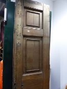 A PAIR OF LARGE OAK PANELLED DOORS. 243cms HIGH