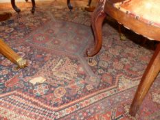 AN ANTIQUE PERSIAN SHIRAZ RUG, A TEKKE BOKHARA RUG AND TWO HAMADAN RUGS.