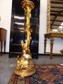 A CARVED GILTWOOD TORCHERE. 118cms HIGH