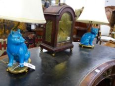 A PAIR OF BLUE ORIENTAL FIGURES OF CATS ON GILT METAL BASES MOUNTED AS LAMPS.