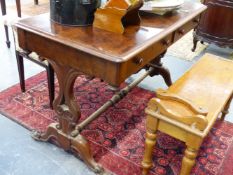 A MID VICTORIAN MAHOGANY TWO DRAWER WRITING TABLE ON CARVED END SUPPORTS. 121cms WIDE